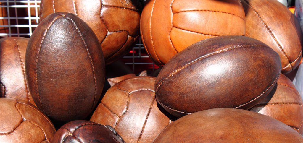 Leather soccer and rugby balls sold in a market stall